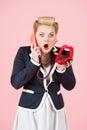 Emotional blonde curly hairstyle girl posing with telephone on pink background Royalty Free Stock Photo