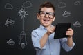 Emotional boy feeling excited while playing games on the tablet Royalty Free Stock Photo