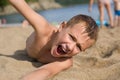 Emotional boy relaxing on the beach. Royalty Free Stock Photo