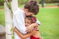 Emotional brother hugging sister in the park outdoors Royalty Free Stock Photo