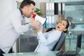 emotional businessman shouting with megaphone at frightened female colleague Royalty Free Stock Photo