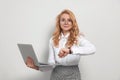 Emotional businesswoman with laptop in turmoil over being late on white background