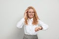 Emotional businesswoman in turmoil over being late on white background