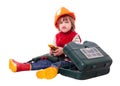 Emotional child in builder hardhat with tools Royalty Free Stock Photo