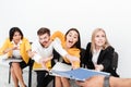 Emotional colleagues sitting in office tries to get folder.