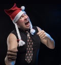 Emotional Comic actor man in cap with braids gesticulates, in anticipation of Christmas and New Year