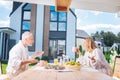 Happy beaming couple having emotional conversation while eating their breakfast