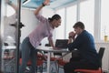 Emotional couple of young colleagues arguing in modern office. African-american business woman shouting at her sad man Royalty Free Stock Photo