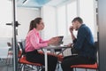 Emotional couple of young colleagues arguing in modern office. Business woman shouting at her sad man assistant, copy Royalty Free Stock Photo