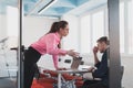 Emotional couple of young colleagues arguing in modern office. Business woman shouting at her sad man assistant, copy Royalty Free Stock Photo