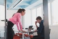 Emotional couple of young colleagues arguing in modern office. Business woman shouting at her sad man assistant, copy Royalty Free Stock Photo