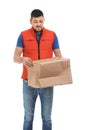 Emotional courier with damaged cardboard box on background. Poor quality delivery service Royalty Free Stock Photo