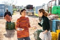 Displeased young female farmer reprimanding asian workwoman Royalty Free Stock Photo