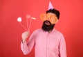 Emotional diversity concept. Guy in party hat celebrate, posing with photo props. Hipster in giant sunglasses Royalty Free Stock Photo