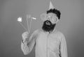 Emotional diversity concept. Guy in party hat celebrate, posing with photo props. Hipster in giant sunglasses Royalty Free Stock Photo