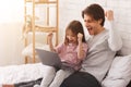 Emotional father and daughter playing computer games Royalty Free Stock Photo