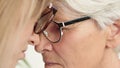 Emotional forehead touch of young and senior woman. Mother and daughter. Close up