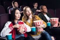 emotional friends with popcorn and soda watching movie Royalty Free Stock Photo