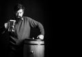 Emotional funny bearded drunk hipster holds craft bottled beer. Beer in the US. Lager and dark beer with keg or barrel