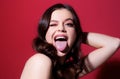 Emotional girl. Beautiful modern model shows tongue. Model with sticking tongue out. Girl showing tongue. Emotional Royalty Free Stock Photo