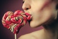 emotional girl with a lollipop over pink background Royalty Free Stock Photo