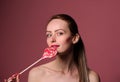 emotional girl with a lollipop over pink background Royalty Free Stock Photo