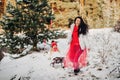 Emotional girl sledding a little girl in a snowy forest.Winter mood