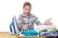 Emotional girl with washed linen around ironing board and iron i Royalty Free Stock Photo