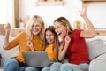 Emotional grandmother, mother and daughter using laptop at home Royalty Free Stock Photo