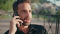 Emotional guy speaking smartphone call sunshine park closeup. Latin man calling Royalty Free Stock Photo