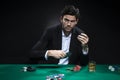 One Emotional Handsome Caucasian Brunet  Pocker Player At Pocker Table With Chips and Cards While Playing Royalty Free Stock Photo