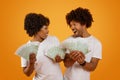 Emotional happy african american spouses showing money Royalty Free Stock Photo