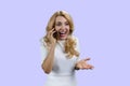 Emotional happy mature blonde woman talking on the phone. Royalty Free Stock Photo