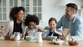 Emotional happy mixed race family preparing weekend breakfast at home. Royalty Free Stock Photo