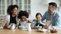 Emotional happy mixed race family preparing weekend breakfast at home.