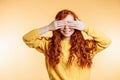 Pretty ginger young woman closing her eyes with hands Royalty Free Stock Photo