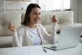 Emotional happy young woman excited about online lottery win notification. Royalty Free Stock Photo