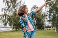 Emotional hipster young girl travels around the city. Cute brunette teen girl with a map. Traveling in summer vacation