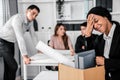 An emotional image of a fired employee packing up her possessions for not being competent