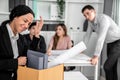 An emotional image of a fired employee packing up her possessions for not being competent