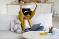 Emotional little black girl with wireless headset using notebook