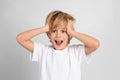 Emotional little boy on grey background Royalty Free Stock Photo