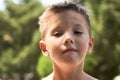 Emotional little boy portrait in the park Royalty Free Stock Photo