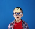 Emotional little boy with question mark on background Royalty Free Stock Photo