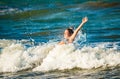 Emotional little girl splashing in the stormy sea Royalty Free Stock Photo