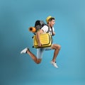 Emotional male tourist with travel backpack and suitcase jumping on turquoise background