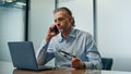 Emotional man calling mobile phone office. Angry businessman talking smartphone Royalty Free Stock Photo