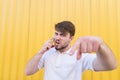 An emotional man calls on the phone, angry and looking into the camera Royalty Free Stock Photo