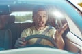 Emotional man feeling furious while driving near dangerous driver