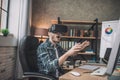 Emotional man playing a game using VR headset